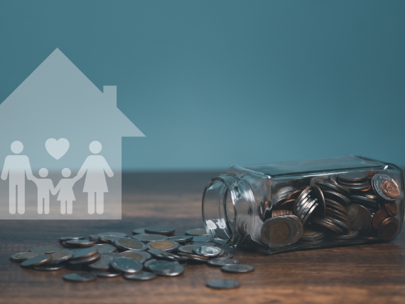 family holding hands and money on a table