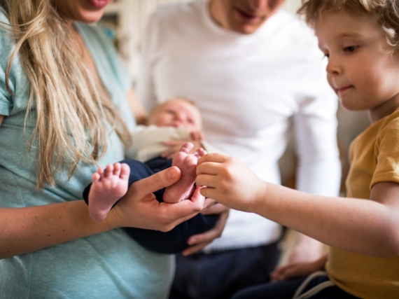 family looking at new baby