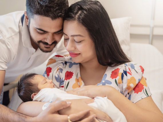 parents holding baby